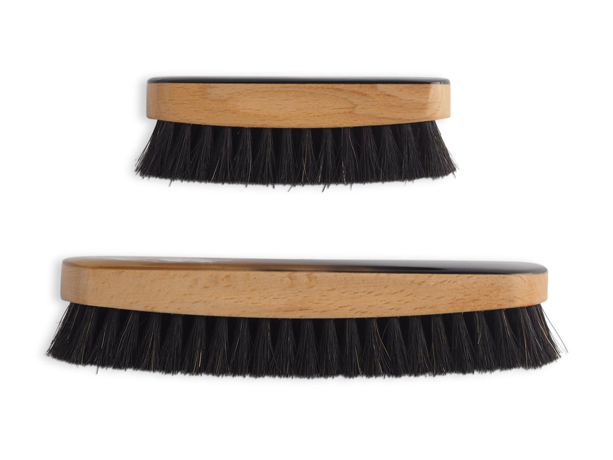 Small and large horn backed clothes and hat brush shown together for size comparison