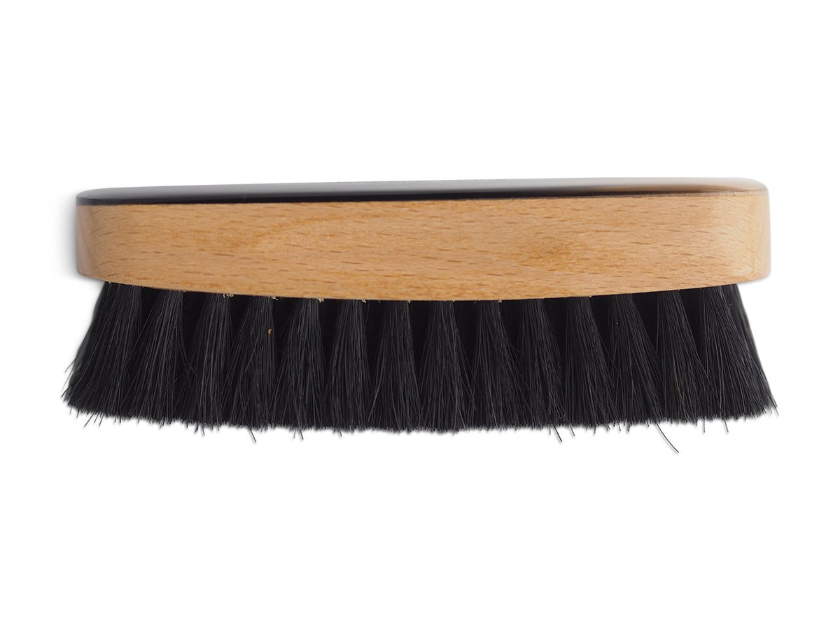 Side view of large horn backed clothes and hat brush