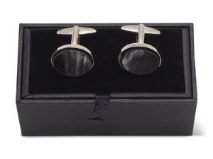 Front view of oval shaped horn cufflinks sitting on box
