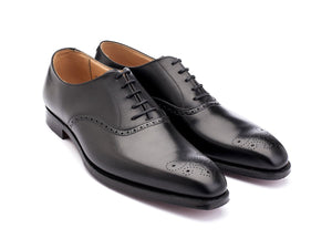 Front angle view of Crockett & Jones Edgware medallion brogue oxford shoes in black calf