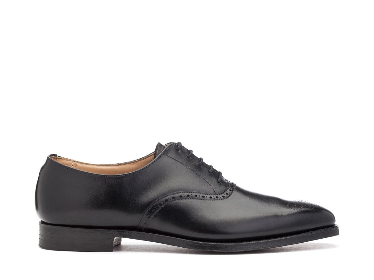 Side view of Crockett & Jones Edgware medallion brogue oxford shoes in black calf