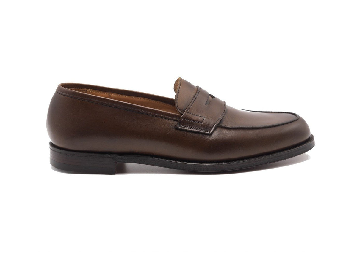 Side view of Crockett & Jones Grantham 2 penny loafers in dark brown burnished calf