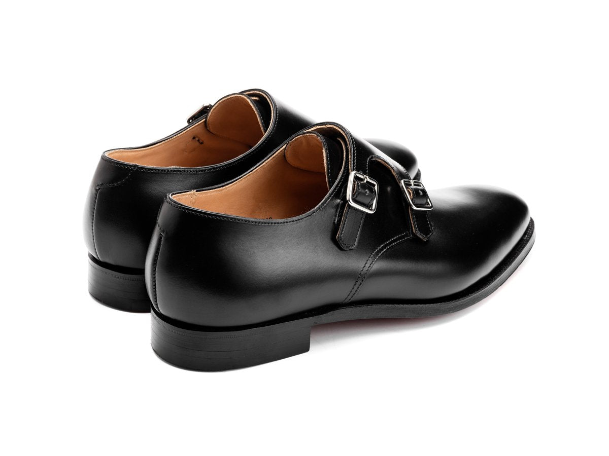 Back angle view of Crockett & Jones Melbourne plain toe Shopovas strap shoes in black calf