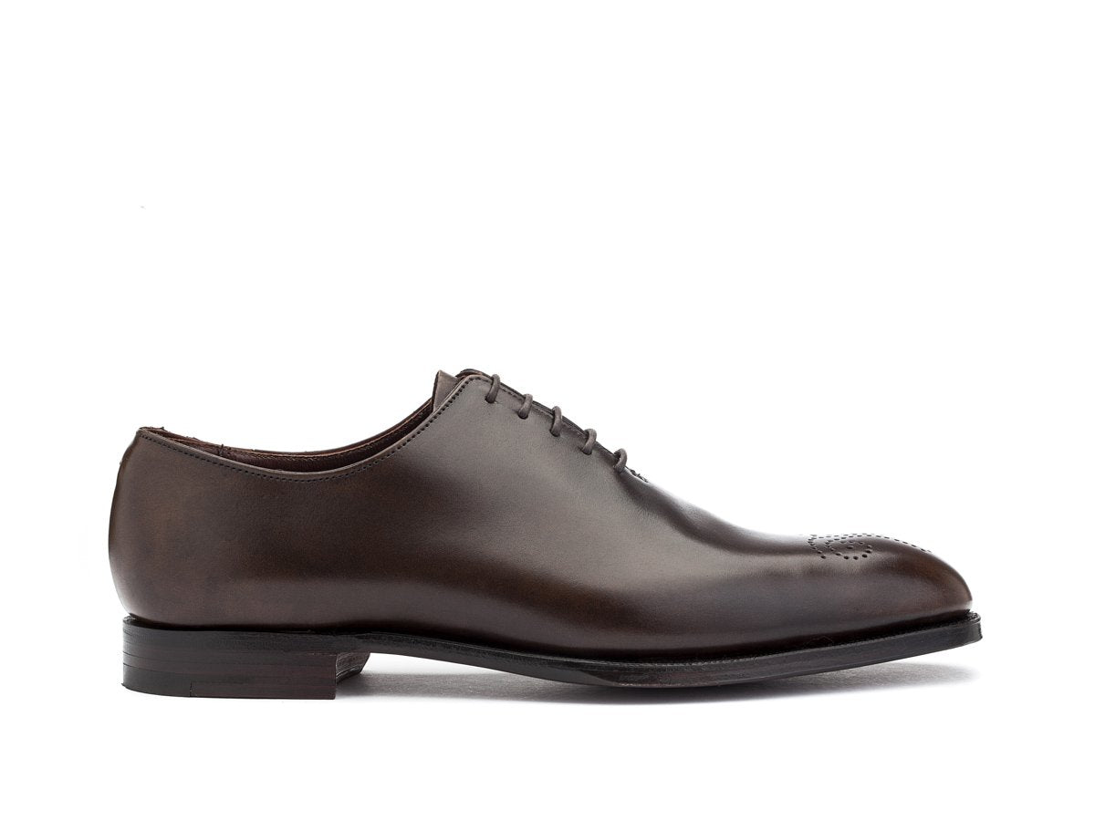 Side view of Crockett & Jones Weymouth wholecut medallion oxford shoes in dark brown antique calf