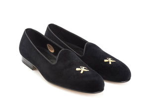 Front angle view of Edward Green Albert slippers in black velvet with hand embroidered gold Shopovas logo on toe