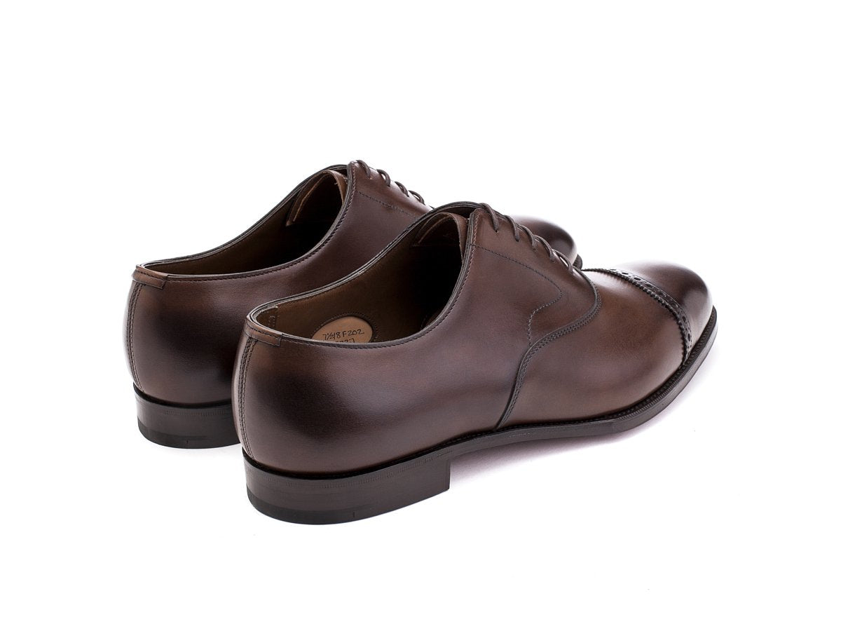 Back angle view of F width Edward Green Berkeley quarter brogue oxford shoes in dark oak antique calf