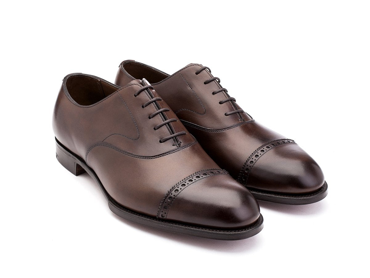Front angle view of F width Edward Green Berkeley quarter brogue oxford shoes in dark oak antique calf