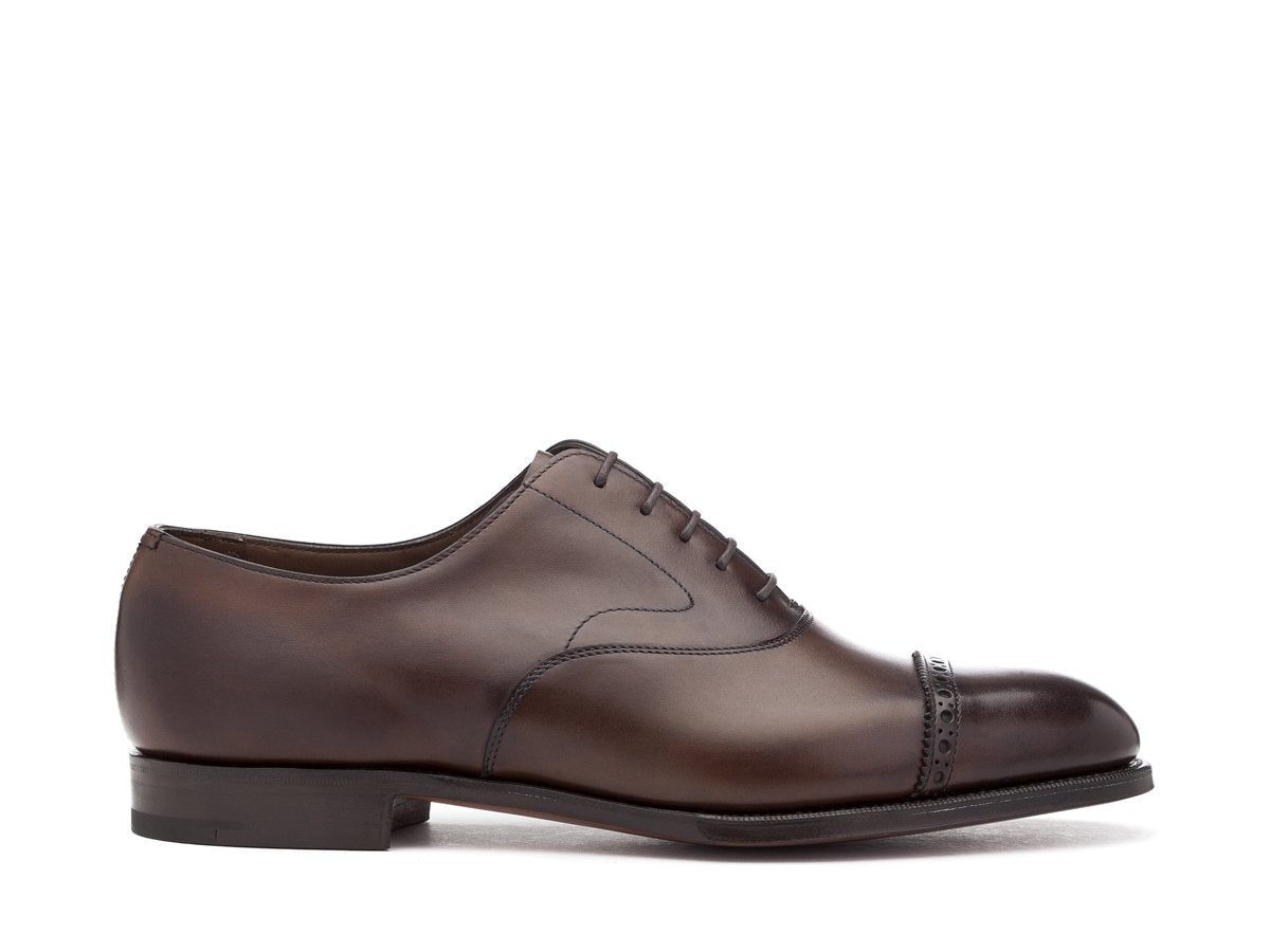 Side view of F width Edward Green Berkeley quarter brogue oxford shoes in dark oak antique calf