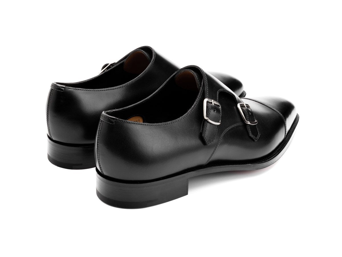 Back angle view of Edward Green Westminster plain captoe Shopovas strap shoes in black calf