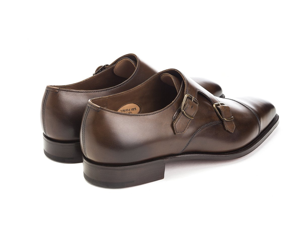 Back angle view of Edward Green Westminster plain captoe Shopovas strap shoes in dark oak antique calf