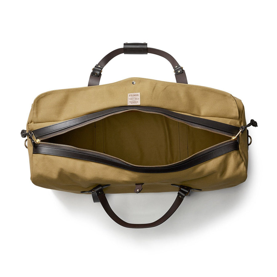 Top view of unzipped Filson Large Duffle bag in tan