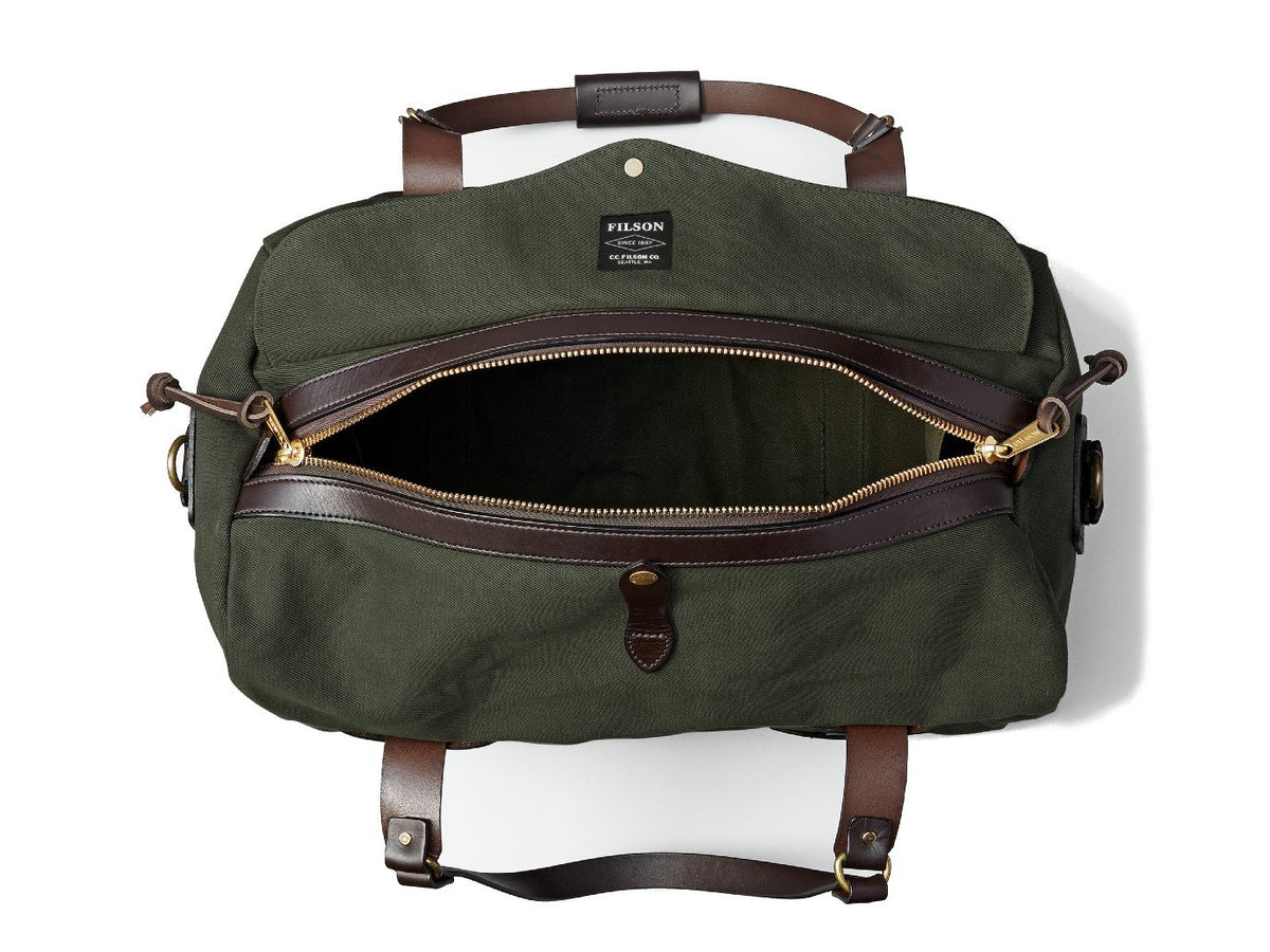 Top view of unzipped Filson Medium Duffle bag in otter green