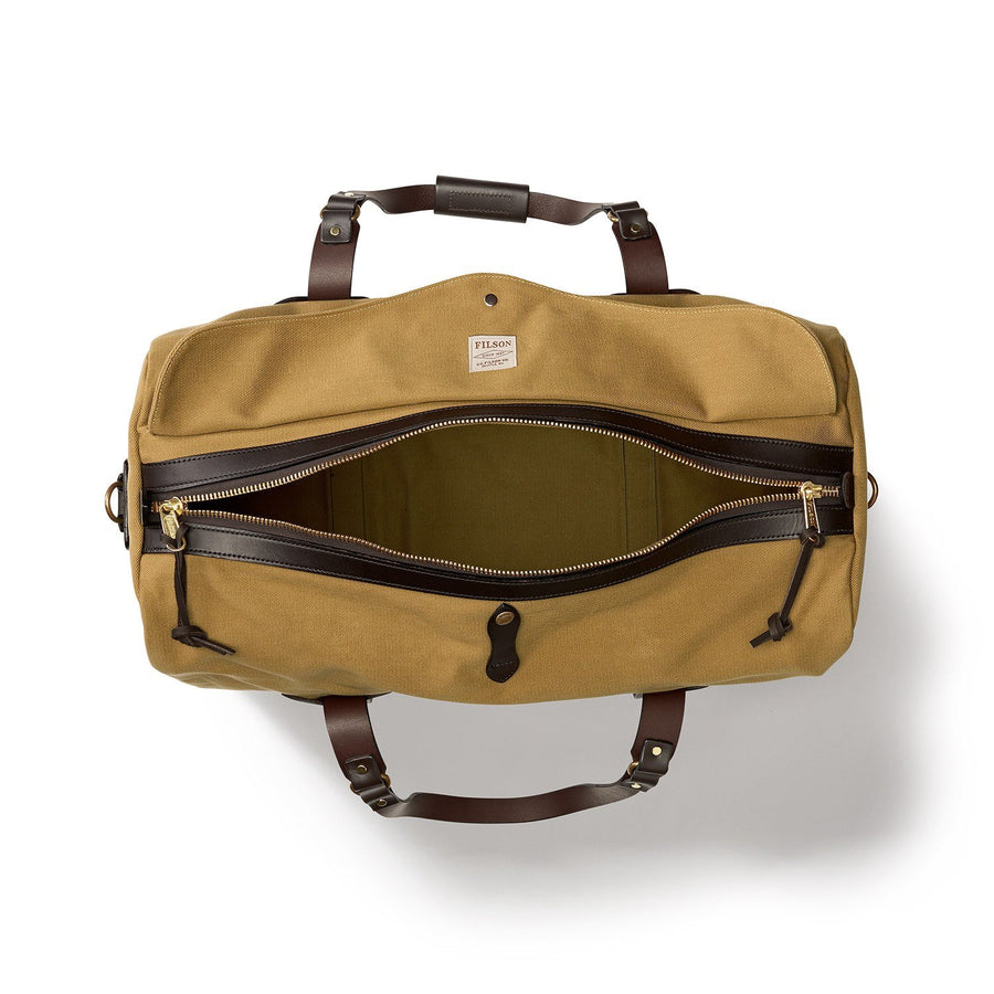 Top view of unzipped Filson Medium Duffle bag in tan