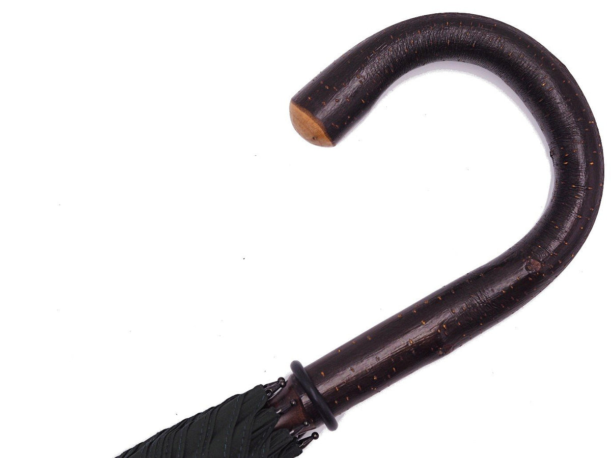 Handle of solid bark chestnut Fox Umbrella with dark green canopy