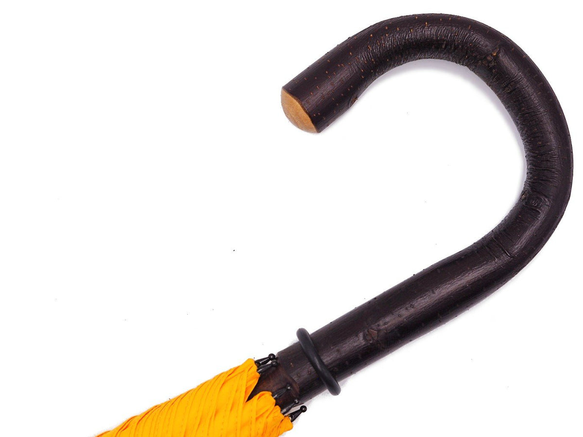 Handle of solid bark chestnut Fox Umbrella with yellow canopy