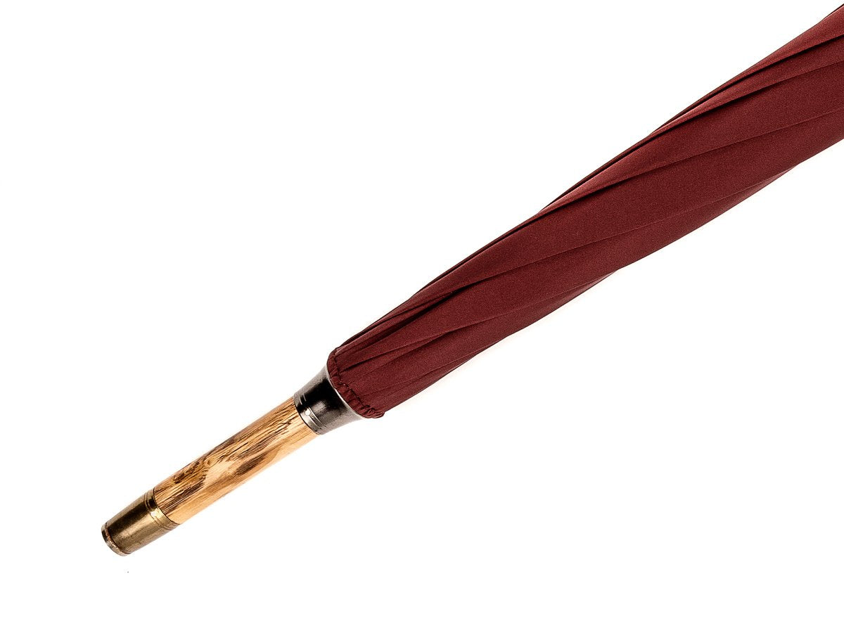 Tip end of solid congo Fox Umbrella with burgundy canopy