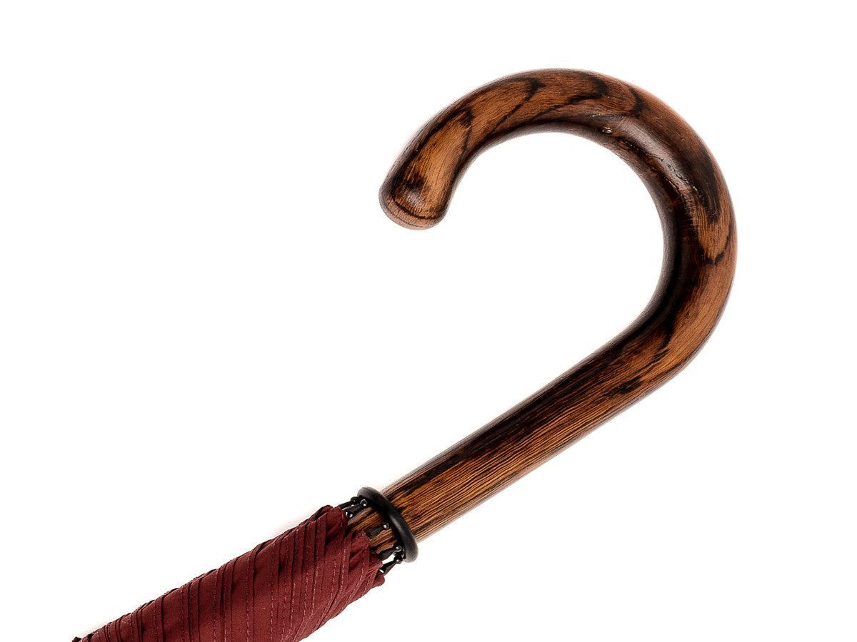 Handle of solid oak Fox Umbrella with burgundy canopy
