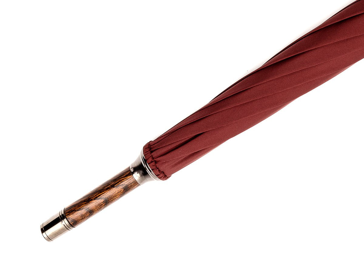 Tip end of solid oak Fox Umbrella with burgundy canopy