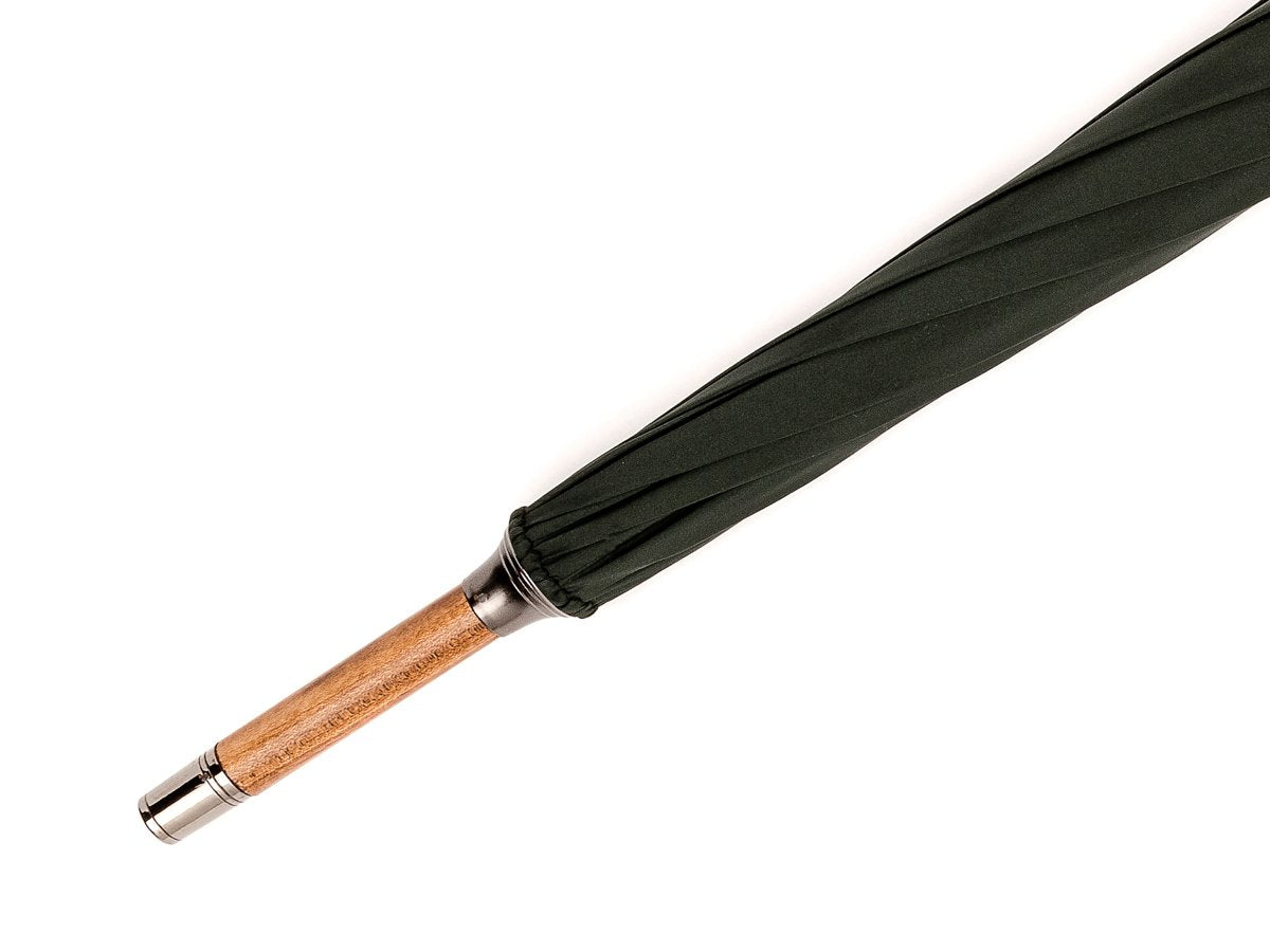 Tip end of solid scorched maple Fox Umbrella with dark green canopy
