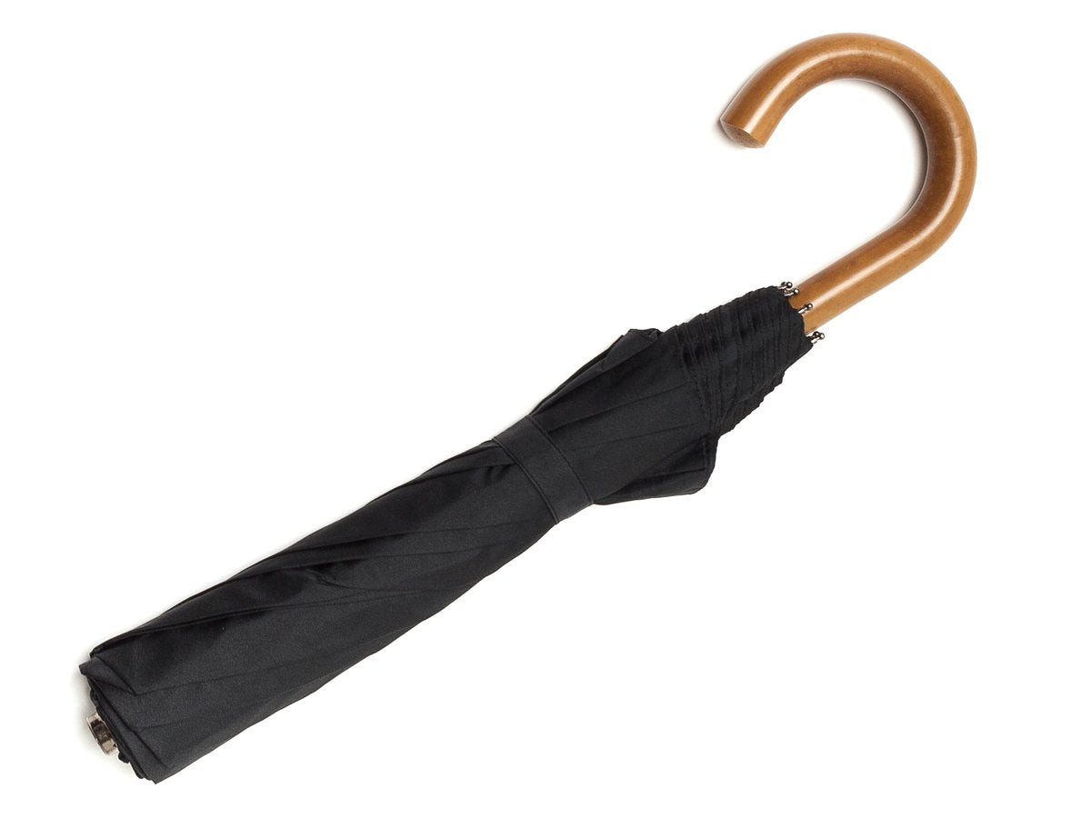 Full length view of malacca handle telescopic Fox Umbrella with black canopy
