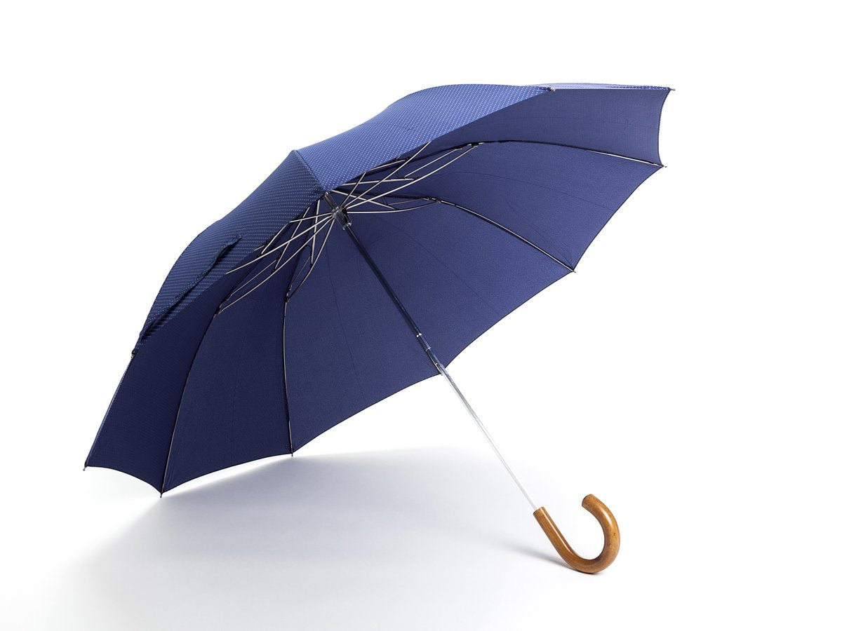 Opened malacca handle telescopic Fox Umbrella with navy and white polka dot canopy