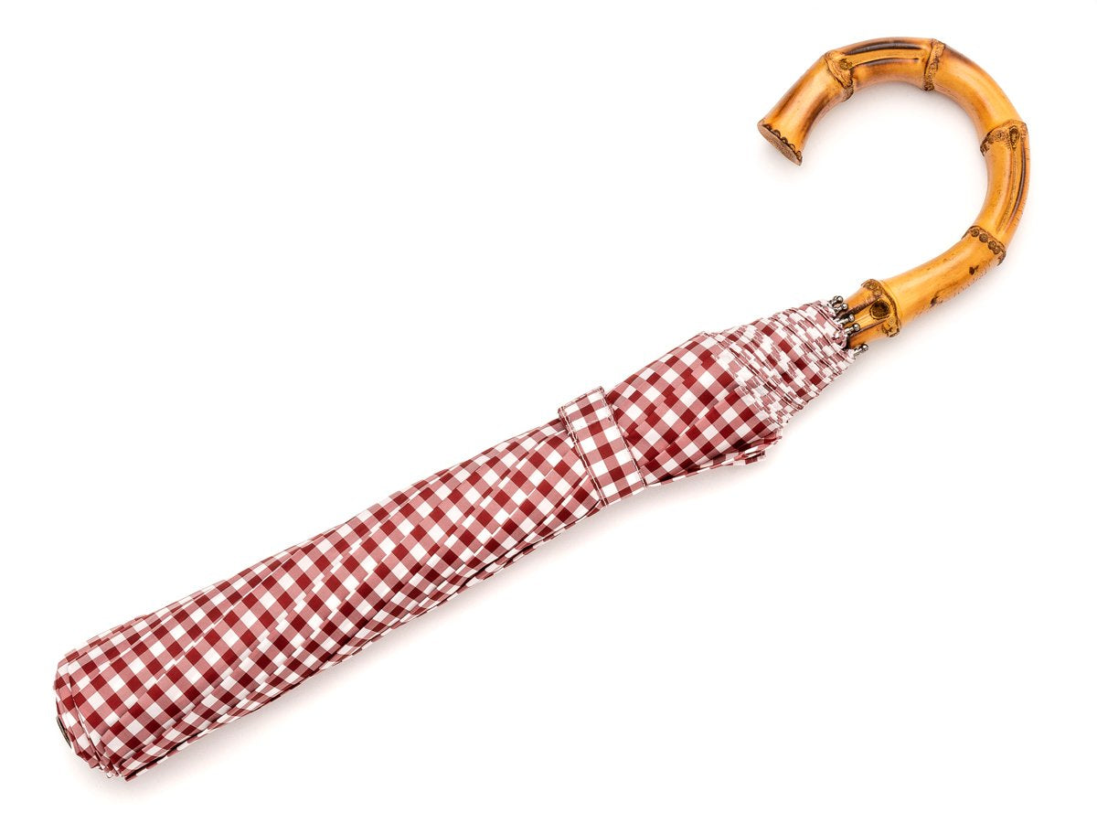Full length view of whangee handle telescopic Fox Umbrella with wine and white gingham canopy