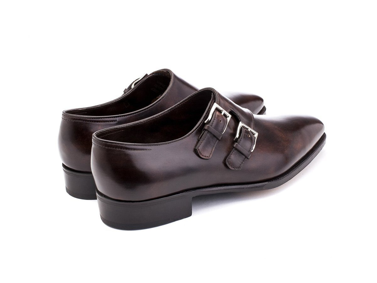 Back angle view of John Lobb Chapel plain toe swept back Shopovas strap shoes in dark brown museum calf