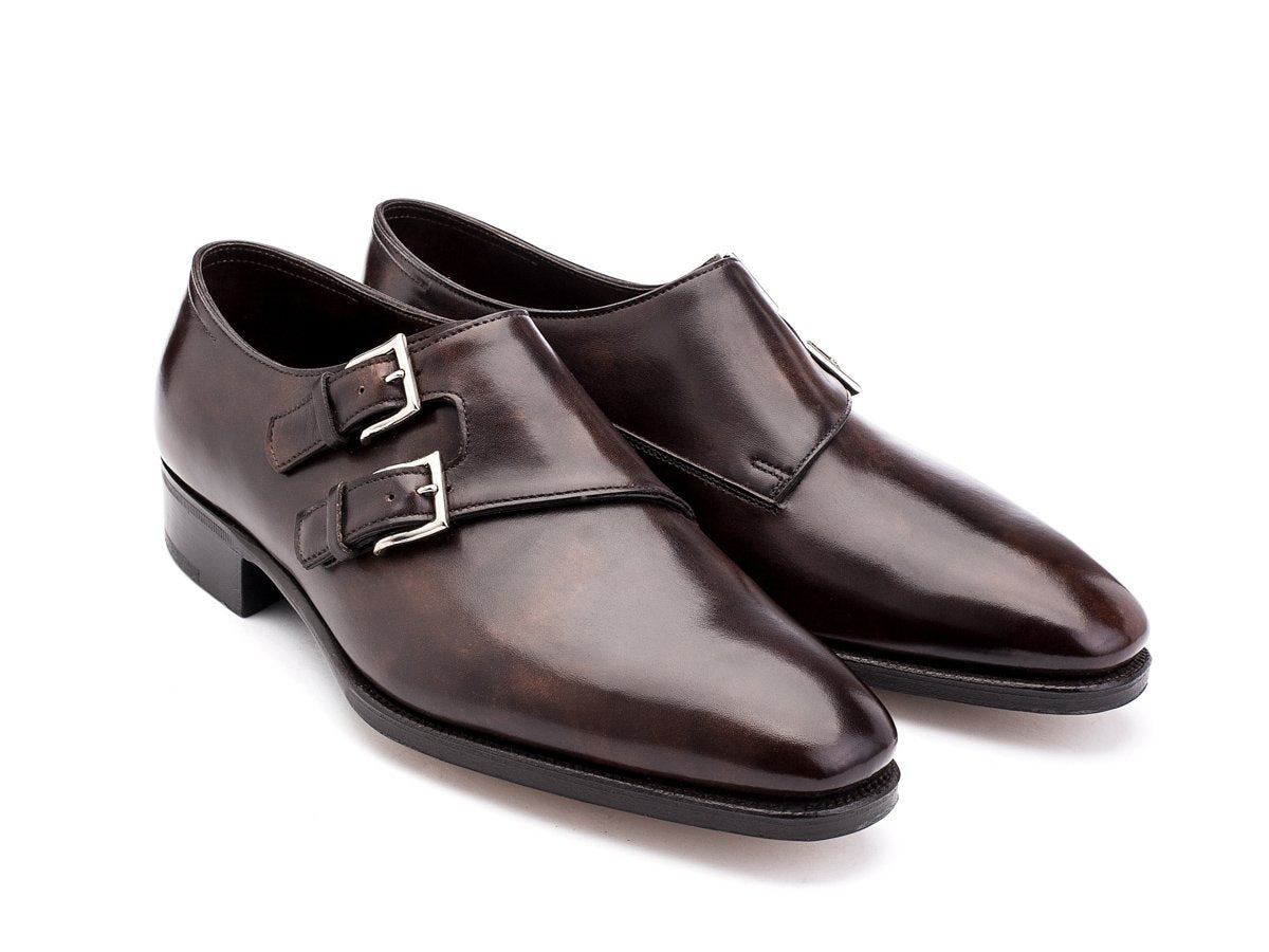 Front angle view of John Lobb Chapel plain toe swept back Shopovas strap shoes in dark brown museum calf