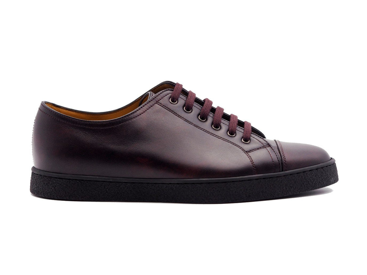 Side view of John Lobb Levah classic tennis sneakers in plum museum calf