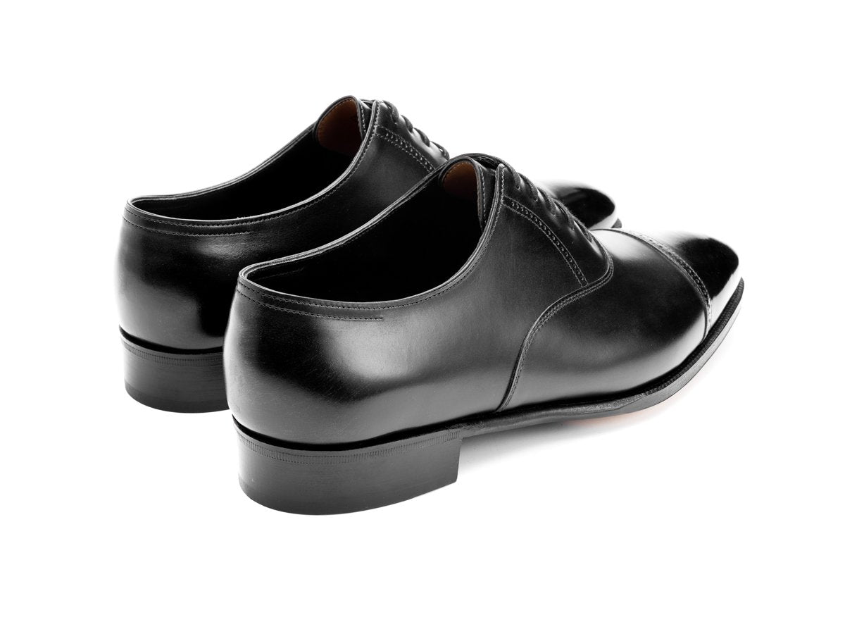 Back angle view of John Lobb Philip II quarter brogue oxford shoes in black oxford calf