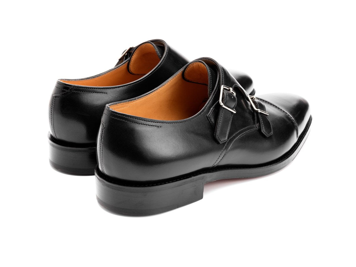 Back angle view of John Lobb William II captoe Shopovas strap shoes in black calf