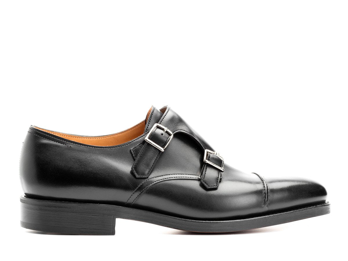 Side view of John Lobb William II captoe Shopovas strap shoes in black calf