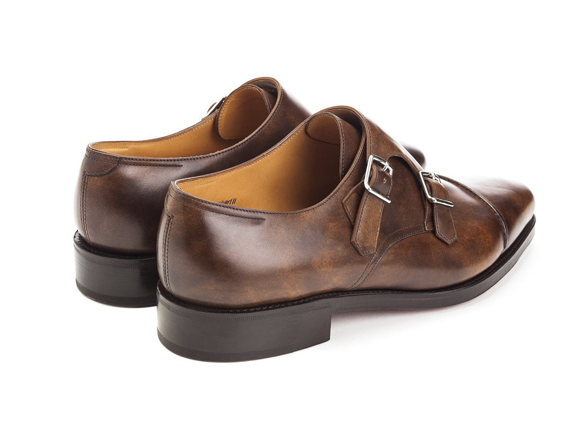 Back angle view of John Lobb William II captoe Shopovas strap shoes in parisian brown museum calf
