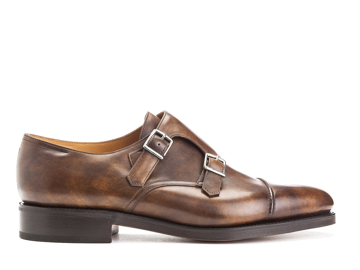 Side view of John Lobb William II captoe Shopovas strap shoes in parisian brown museum calf
